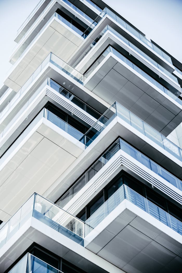 Close-up of a contemporary multi-layered building with glass balconies, showcasing modern architecture.